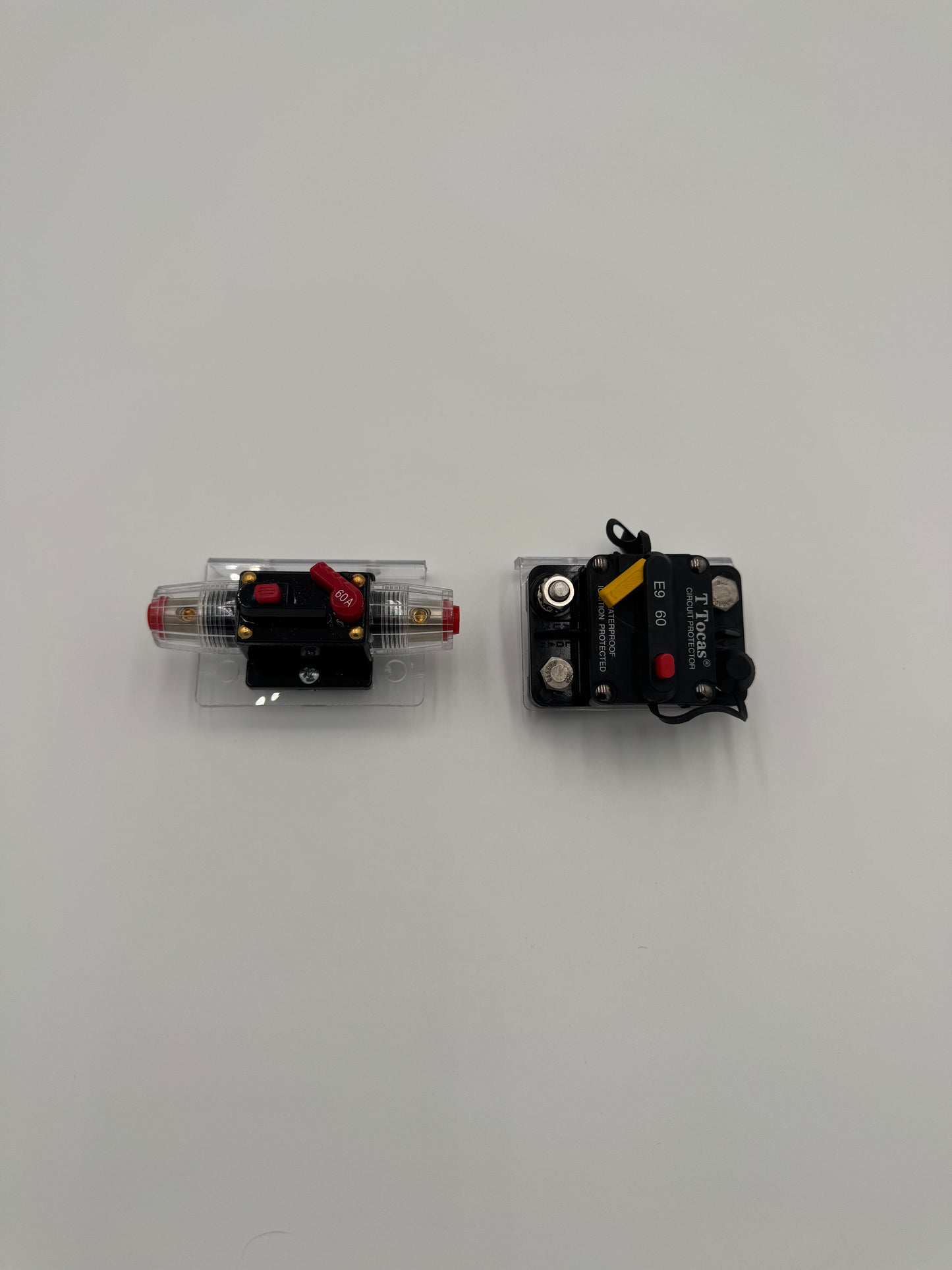 two bass boat circuit breaker switches mounted to a clear plastic mounting bracket
