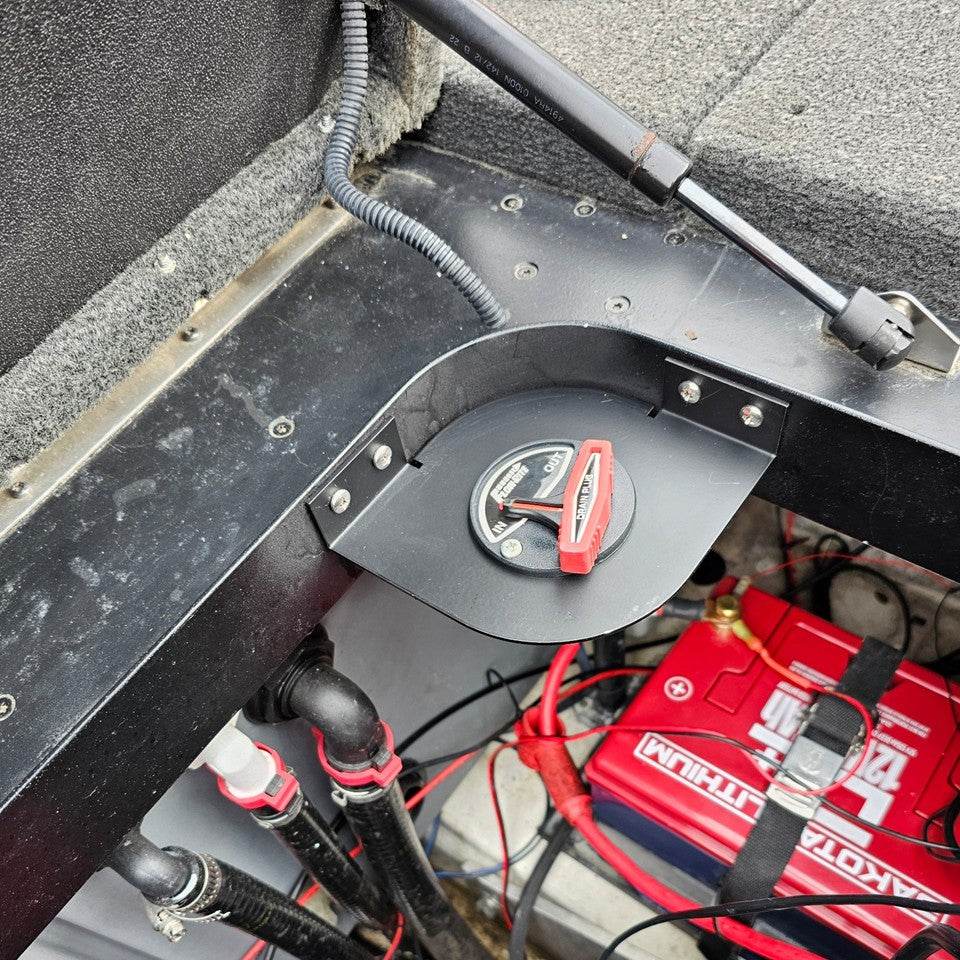 Skeeter Remote Drain Plug Switch corner bracket in matte black metal, mounted with a red rotary control and battery wiring