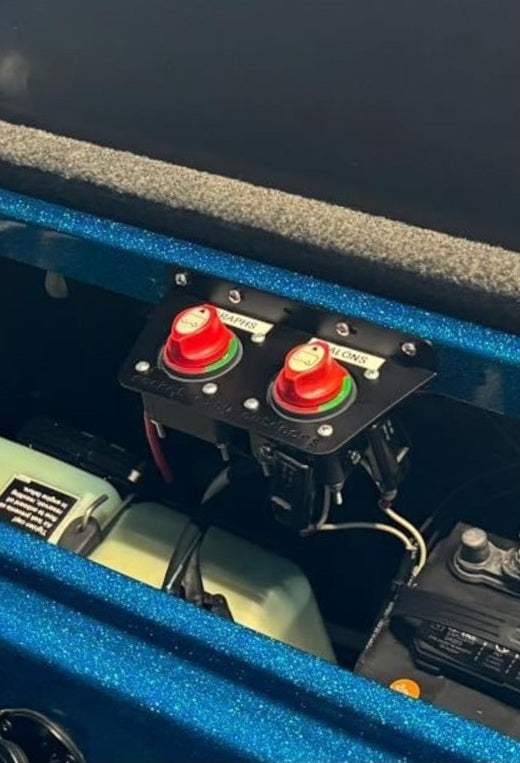 Universal dual battery switch mounting bracket in matte black holding two red rotary battery switches side by side