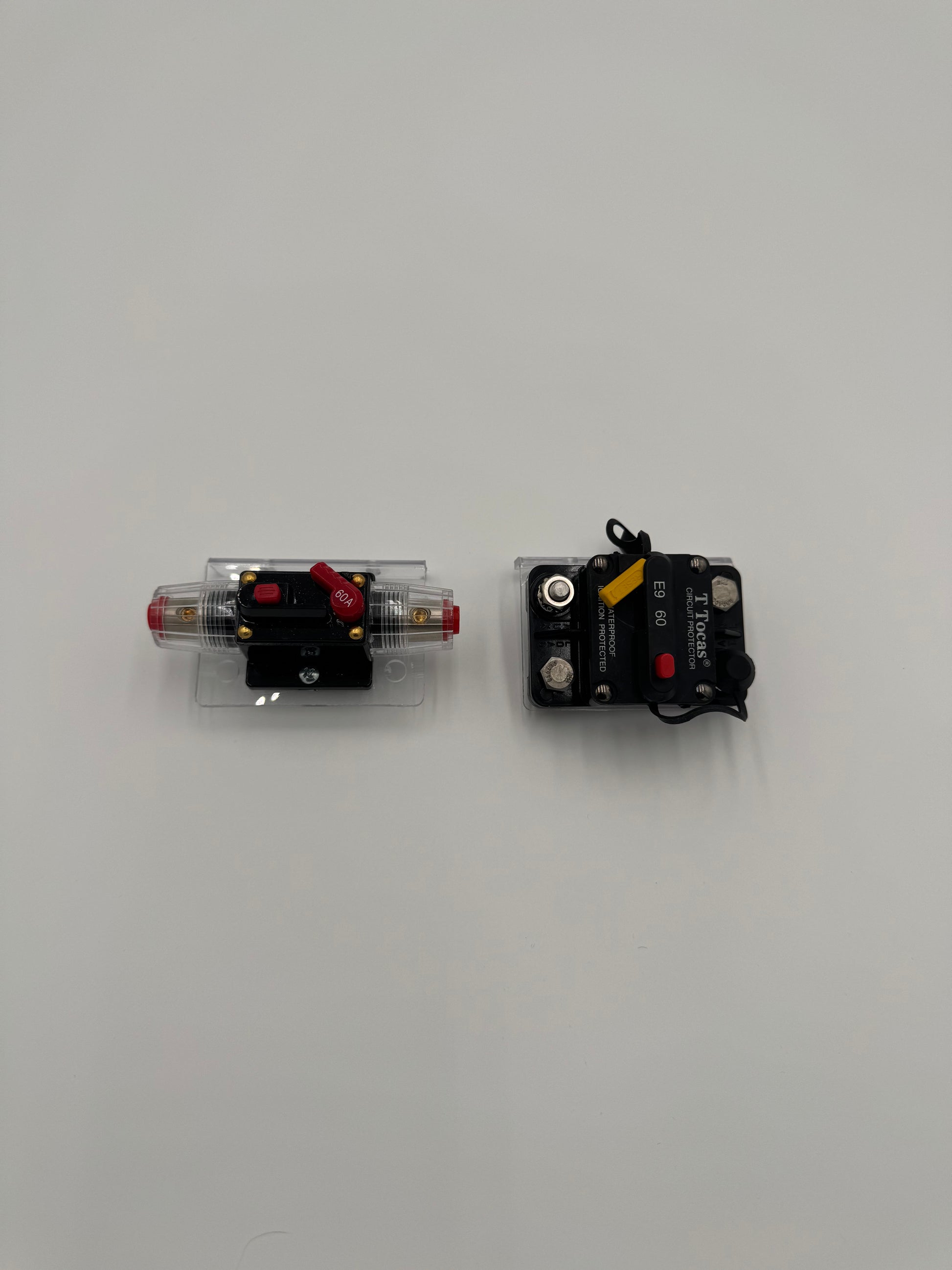 two bass boat circuit breaker switches mounted to a clear plastic mounting bracket