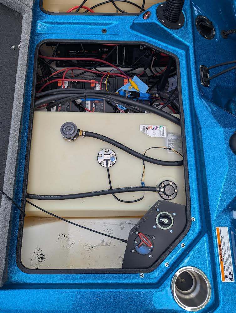 Bass Cat Puma Caracal Double Battery Switch bracket visible in a boat compartment, black corner mount with two rotary switches