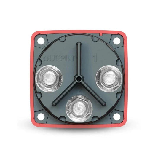 Blue Sea 6007 battery selector switch with a gray circular face, red square housing and three silver terminals. — reference image, not confirmation of the brand or specifications of the unbranded switch sold by RCO