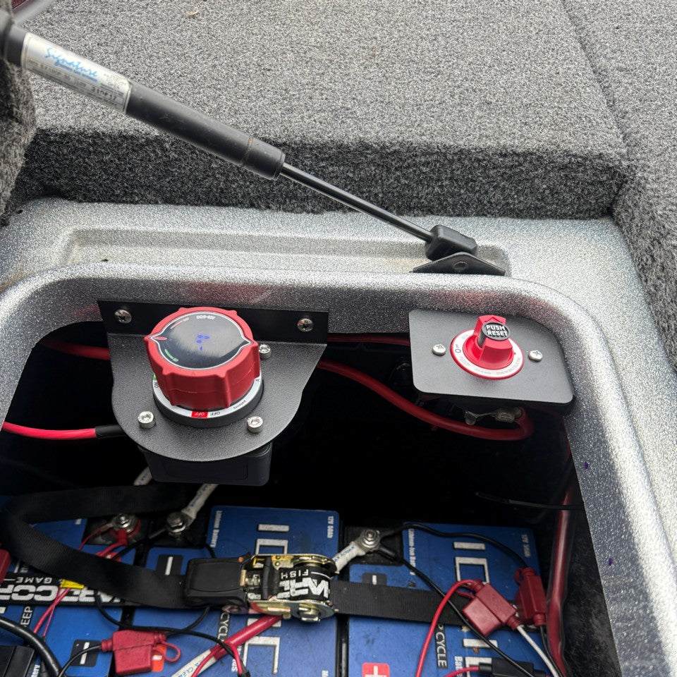 Egis 4701 Circuit Breaker Bracket, black metal mount holding a red circuit breaker switch beside a red battery switch