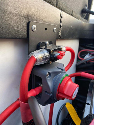 Flat Bass Boat Battery Switch bracket in matte black metal, mounted with a red rotary switch and heavy red cables