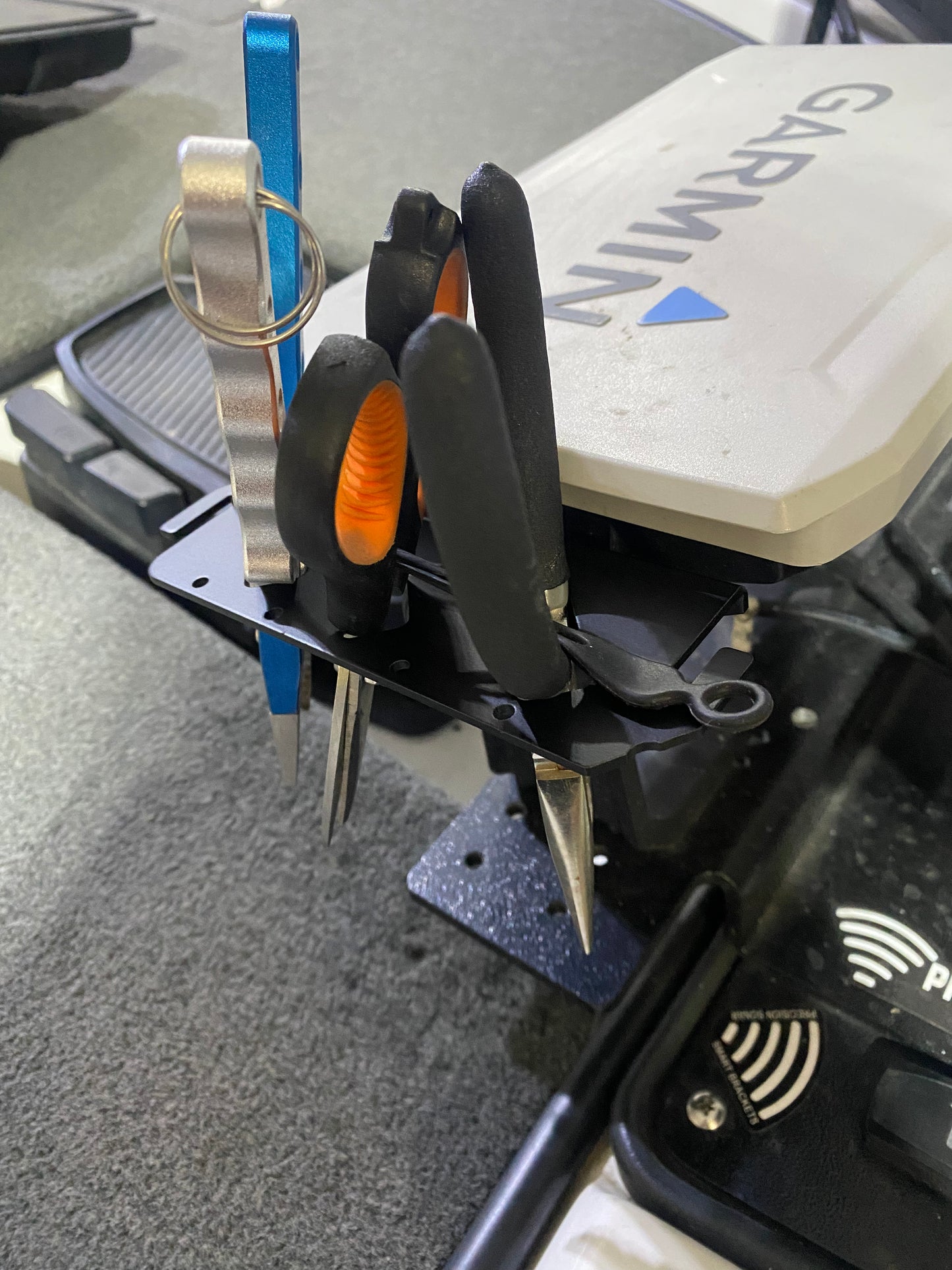 Garmin echomap marine graph tournament fishing tool holder organizer accessory on a skeeter ranger triton nitro Phoenix caymas avid bass boat highlighting the elastic tie down strap