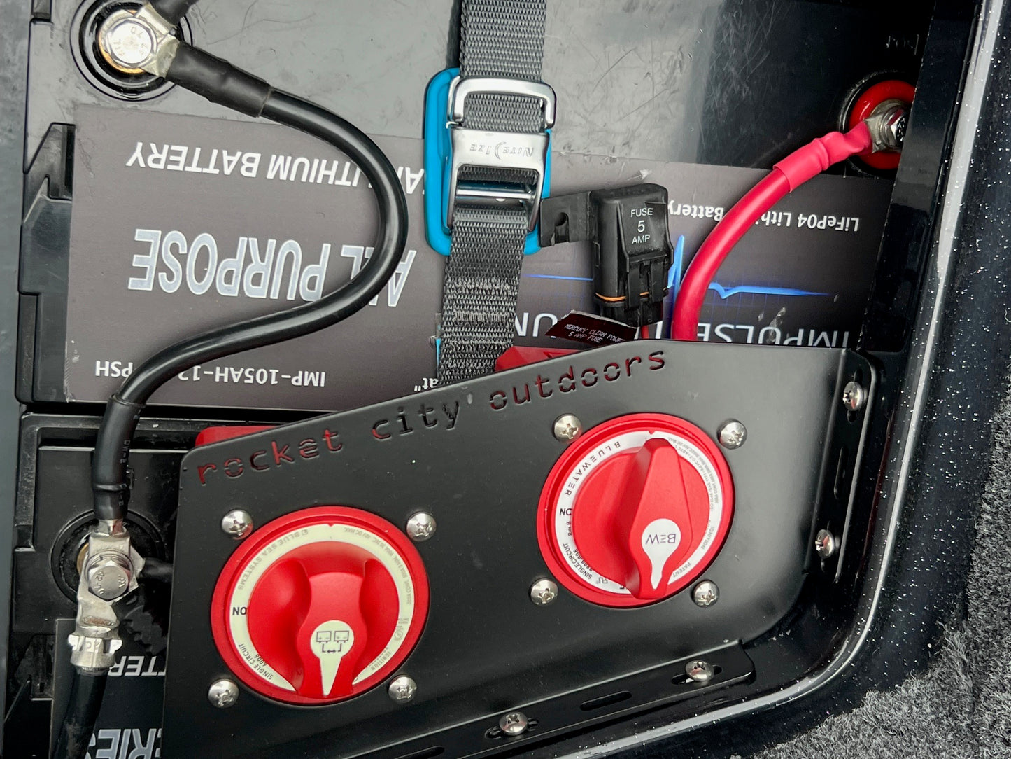 Close-up of a bass boat battery management system with blue sea systems switches