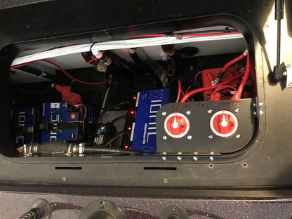 Skeeter Dual Battery Switch mounting bracket with two red rotary switches on a black rectangular metal plate