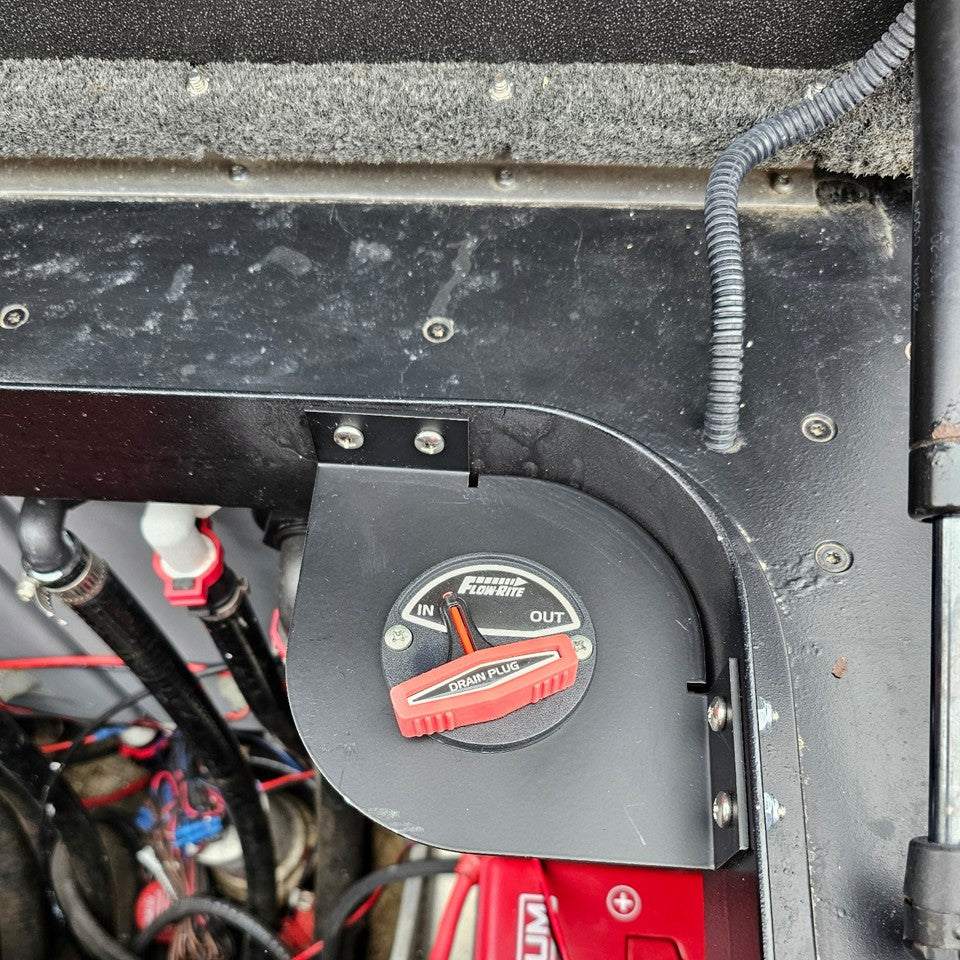 Skeeter Remote Drain Plug Switch bracket in matte black metal, corner-mounted around a red Flow-Rite drain plug control