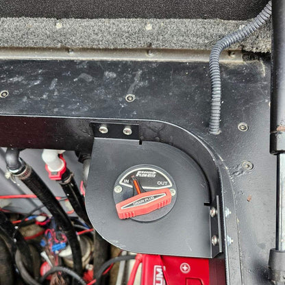 Skeeter Remote Drain Plug Switch bracket in matte black metal, corner-mounted around a red Flow-Rite drain plug control