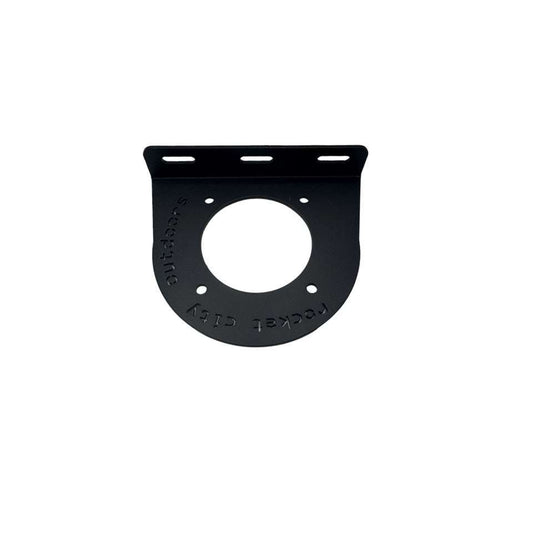 Universal battery switch mounting bracket in matte black coated aluminum, with a rounded plate, large center opening and slotted mounting lip.
