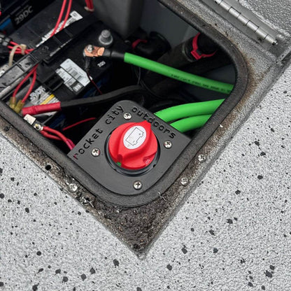 Xpress Battery Switch Corner Bracket, matte black corner mount holding a red battery switch among boat wiring