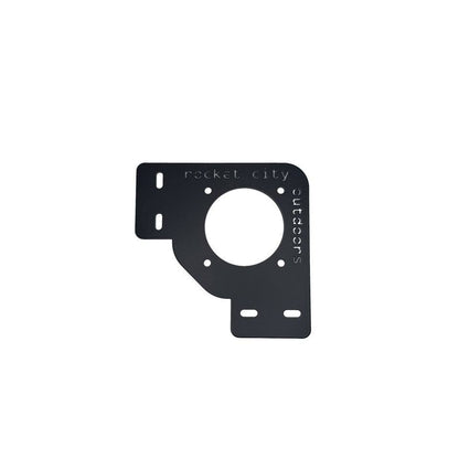 Xpress Battery Switch Corner Bracket in matte black powder-coated aluminum, with a large circular cutout and slotted mounting holes